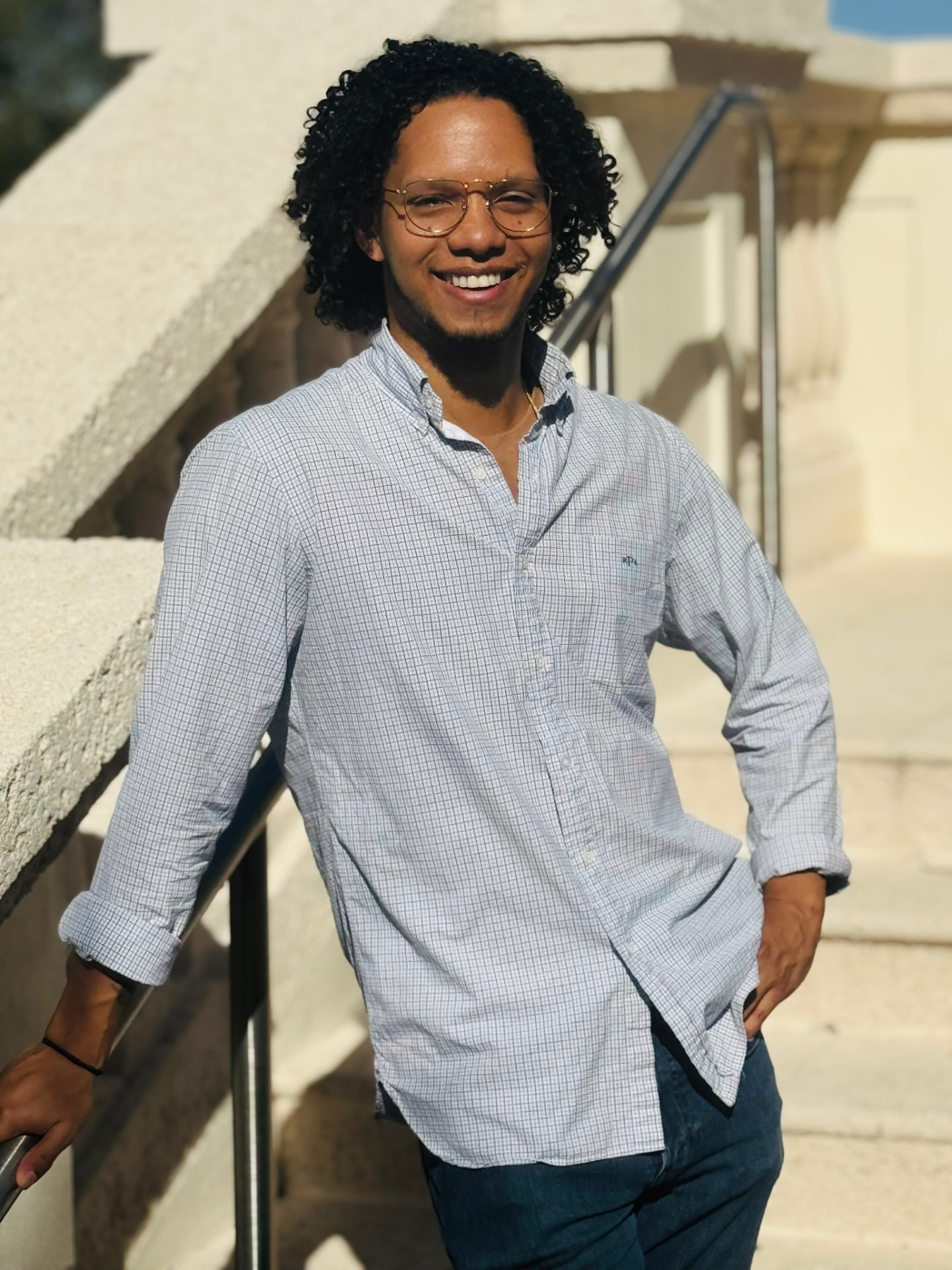 Julio Mata, founder of Good Company, smiling on sunlit steps
